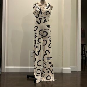 Black and cream romper, ties at the shoulder and zips in the back.
